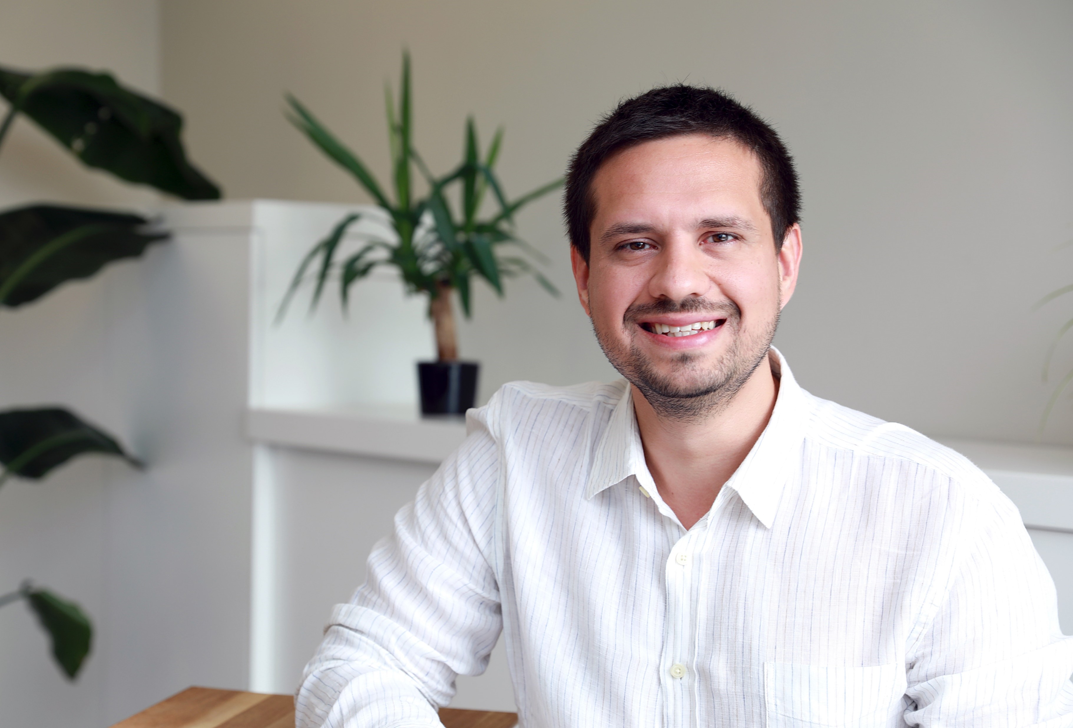 A photograph of Onur Gungor captured in an office setting.
